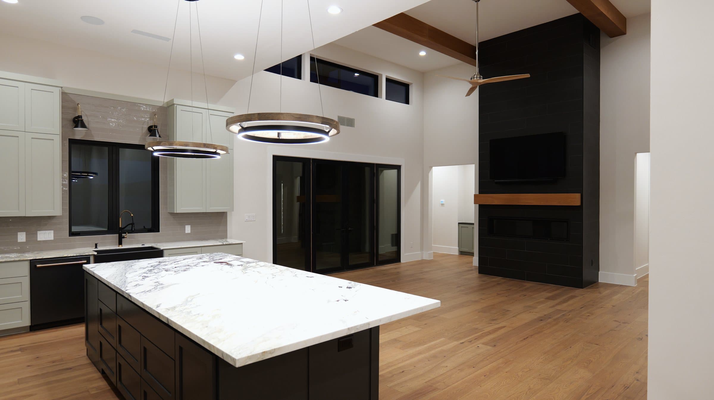 Kitchen island looking toward a dark-tile fireplace and vaulted living room